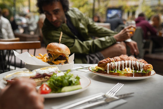 A man sitting at a table with plates of food