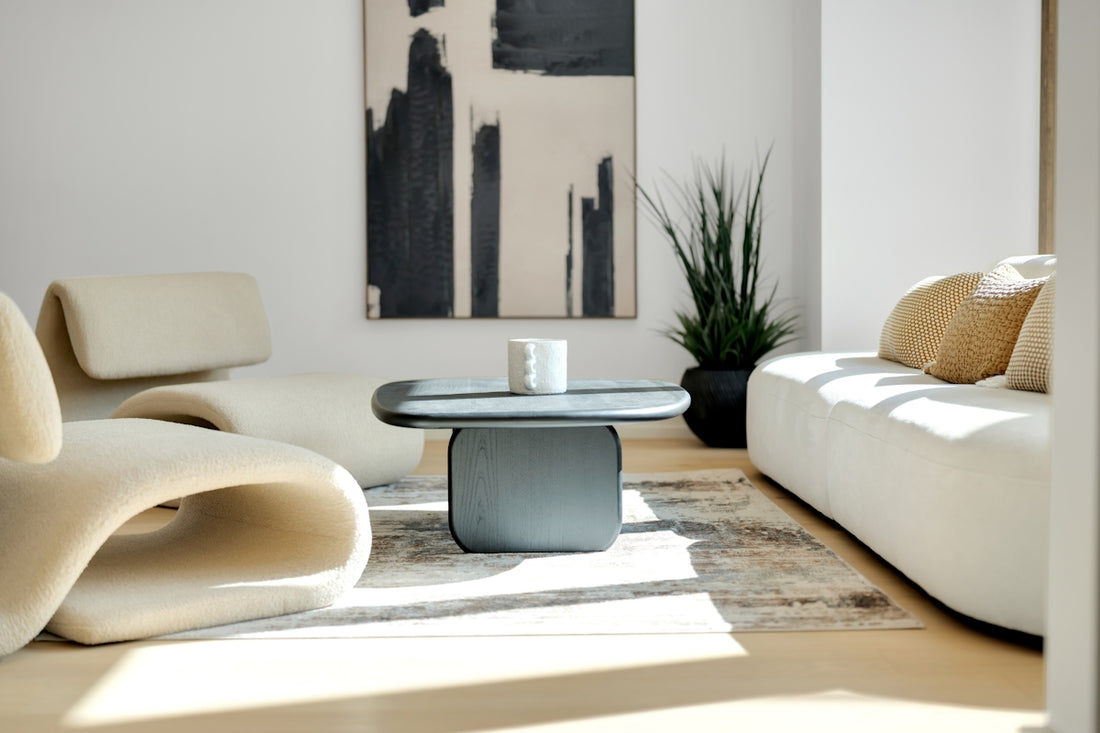 Modern living room with abstract art and plush furniture.