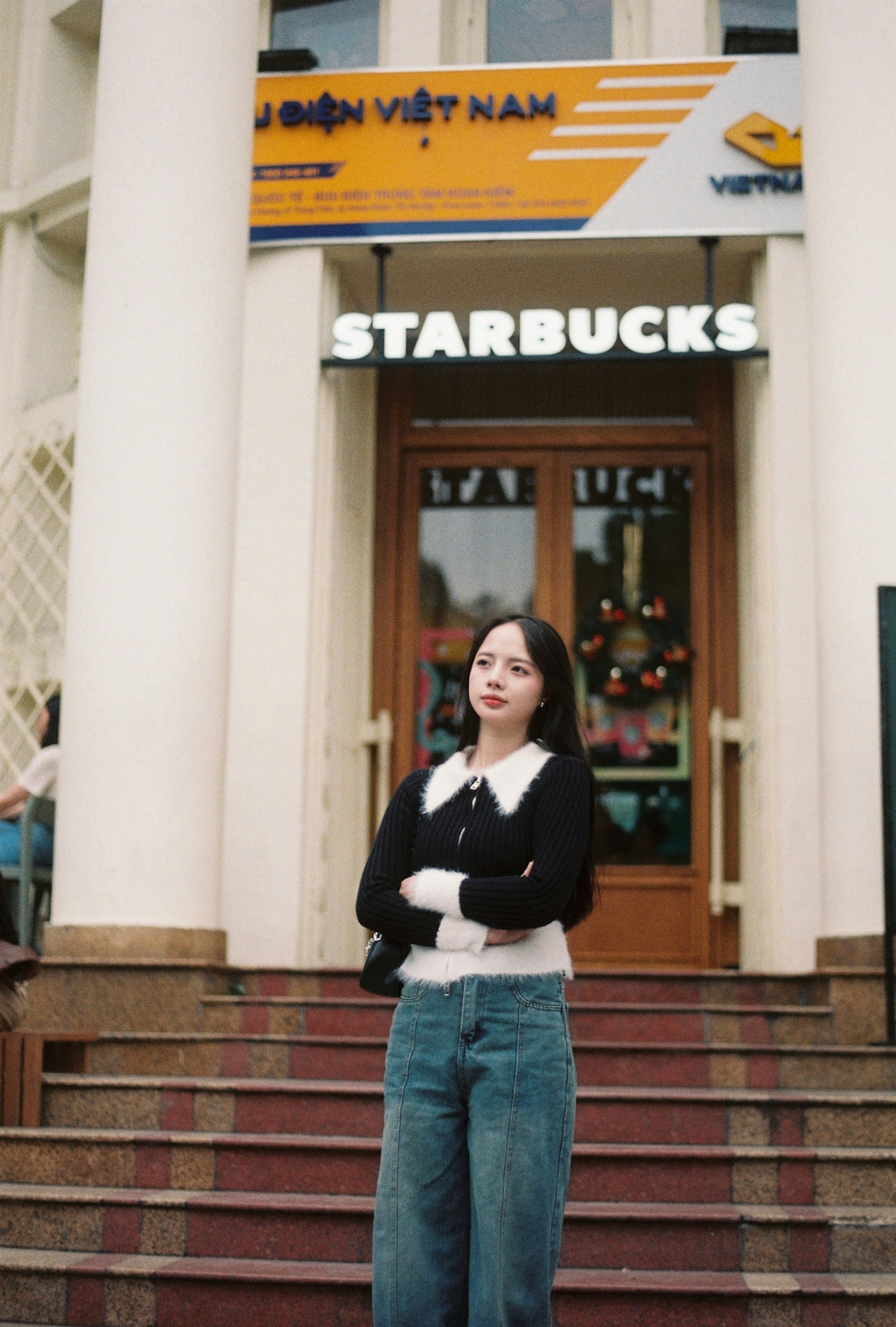 Young woman standing in front of starbucks