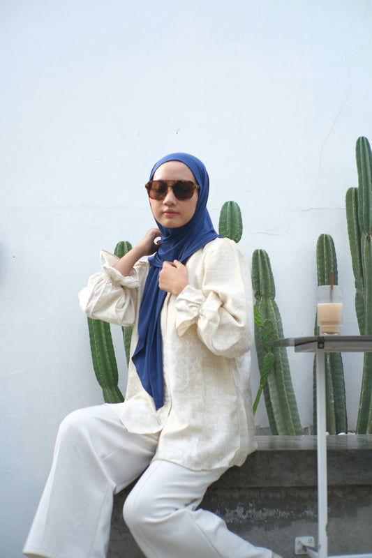 Woman in hijab and sunglasses with cacti