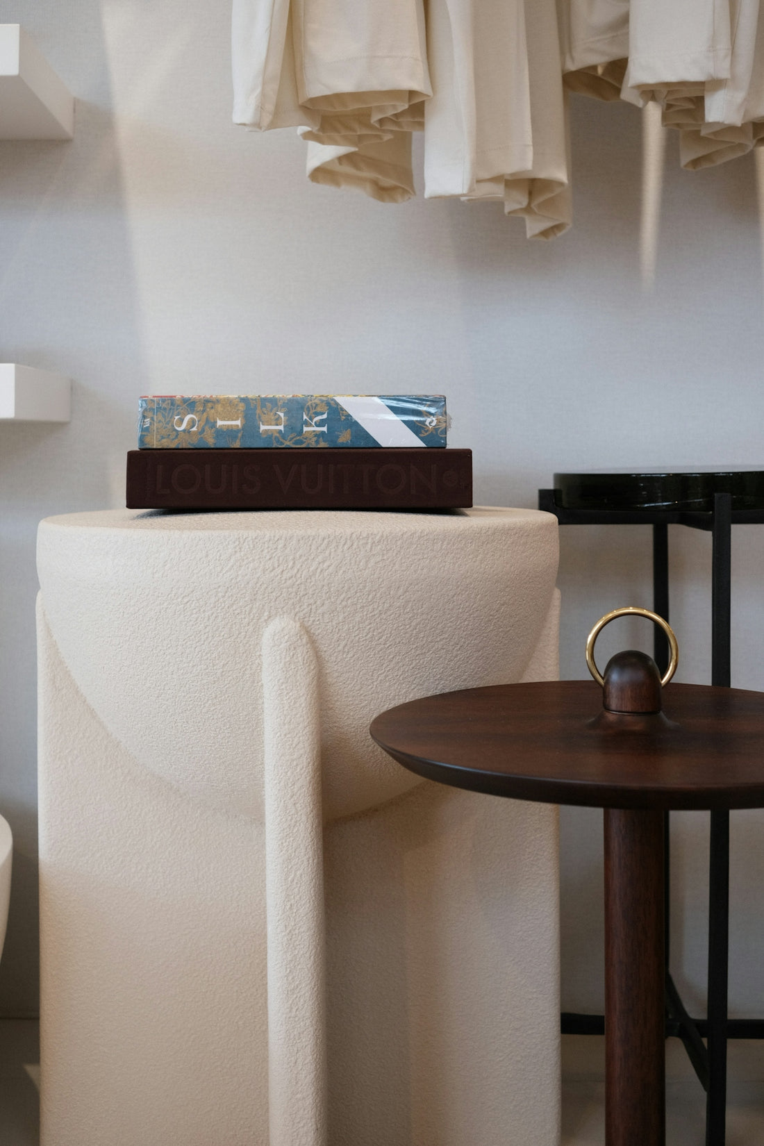 A book with louis vuitton on a pedestal.