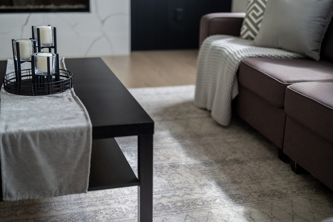 Modern living room with dark coffee table and sofa.