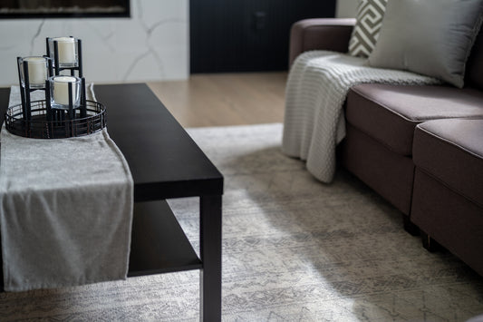 Modern living room with dark coffee table and sofa.