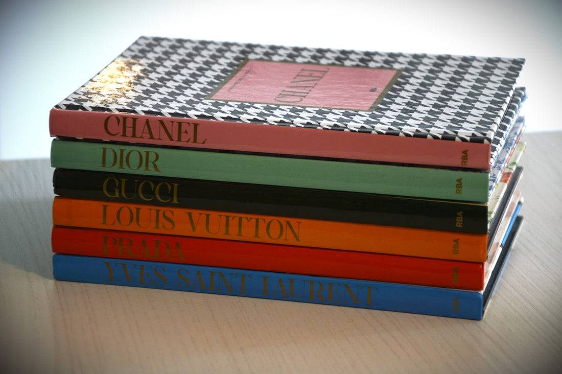 Stack of fashion books with designer names