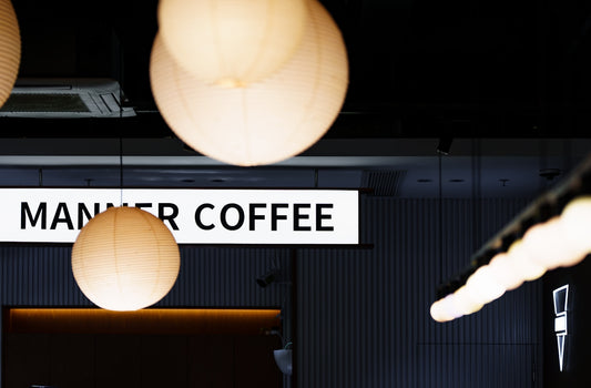 Modern interior with hanging lamps and manner coffee sign